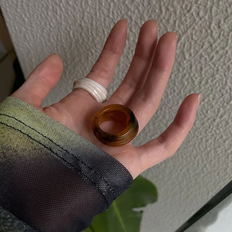 Chinese style resin ring with geometry shape and irregular width in brown or white.
