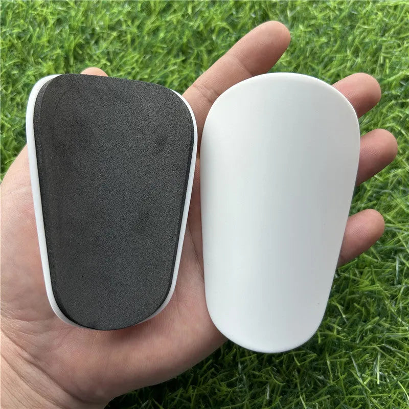Extra small plastic football shin guards in black or white colour options