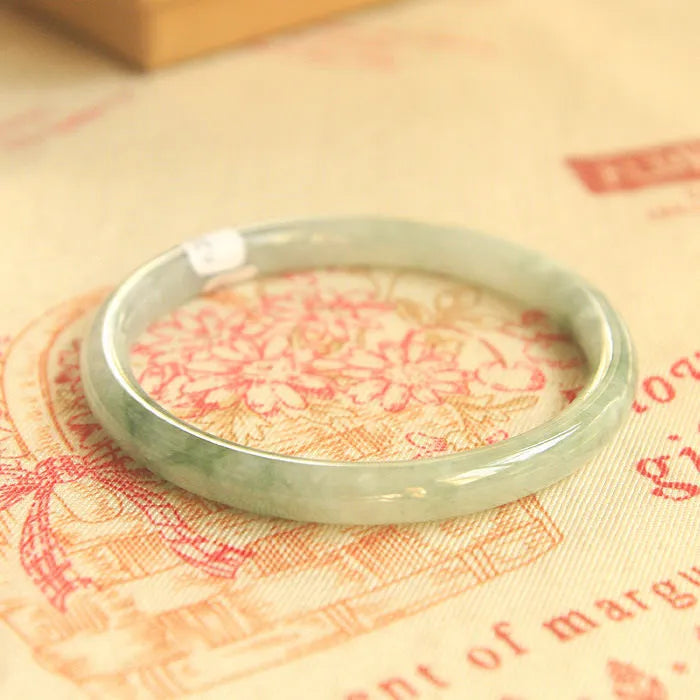 Green handmade jade waxy student bracelet with geometric beads in Chinese style, showing adjustable sizing options