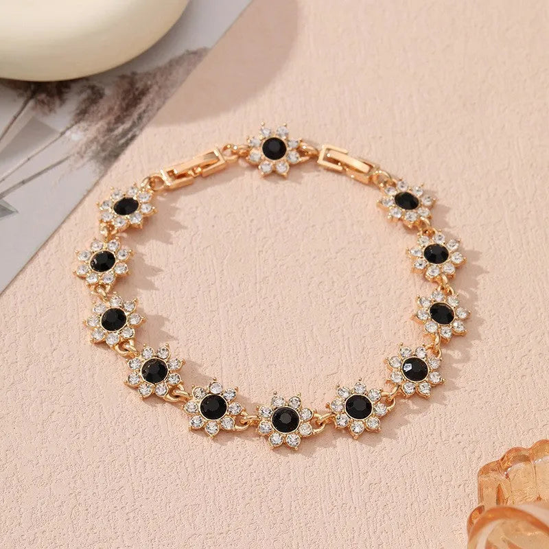 Flower design fashion bracelet in zinc alloy showing electroplated colour options with crystal and simulated diamond elements