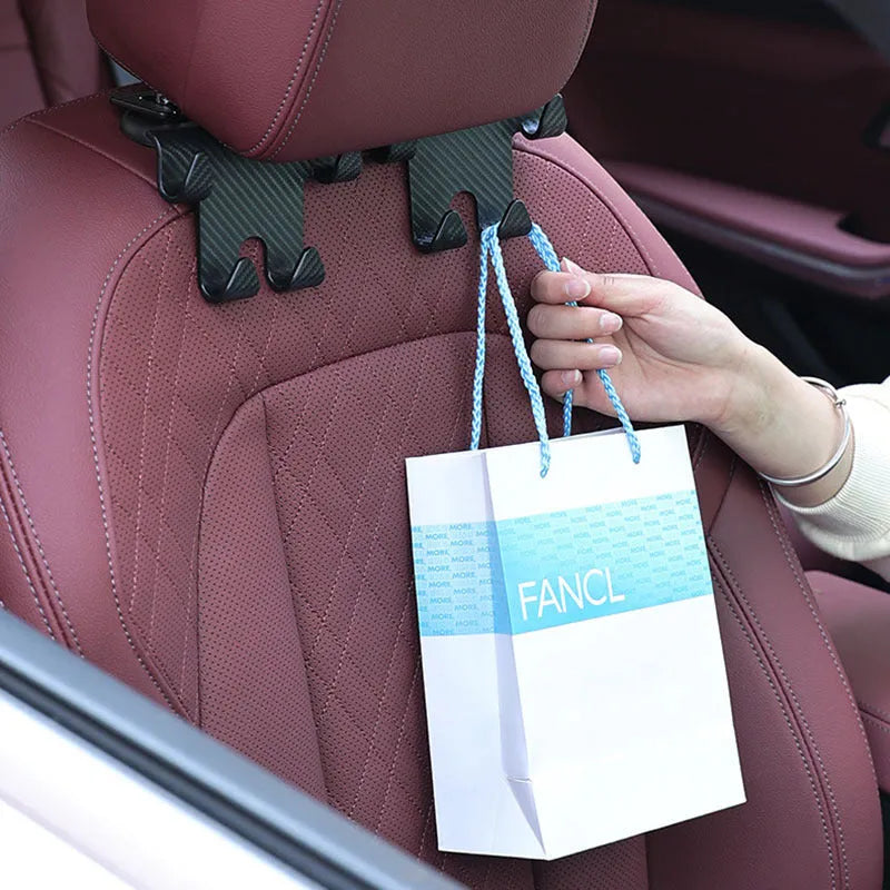 Black ABS car multifunction hook with carbon fibre pattern and integrated phone bracket for rear seat storage.