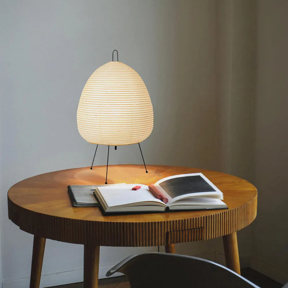 Japanese-style paper table lamp with handmade shade and aluminium base on wooden surface