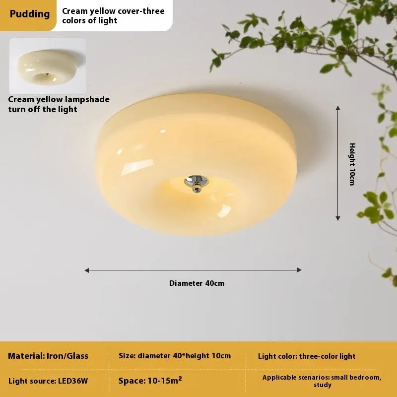 American-style antique finish ceiling lamp with cream coloured shade in bedroom setting