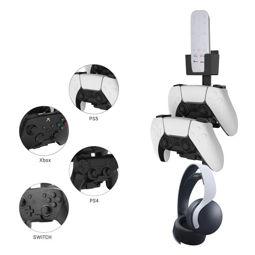 White wall-mounted plastic hook holding a black game controller and TV remote.