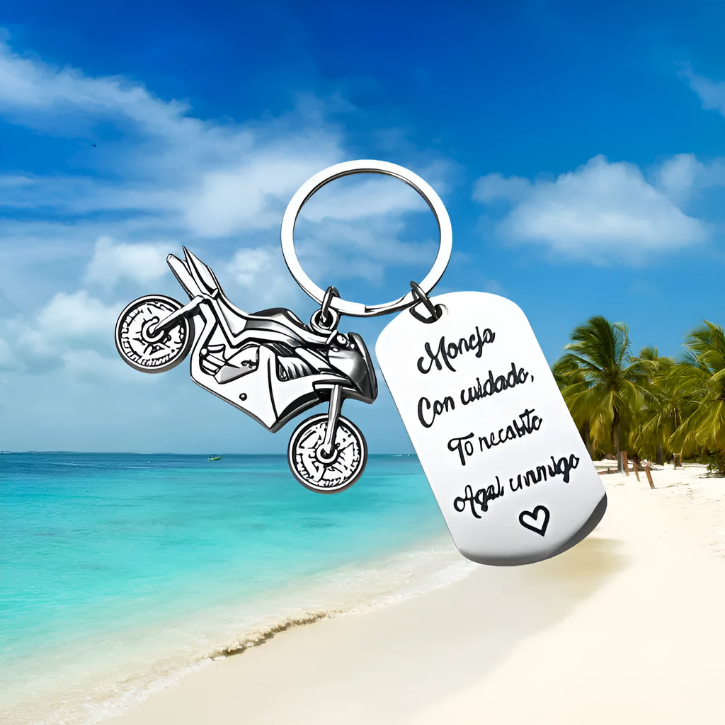 Stainless steel keychain with a motorcycle design presented on a velvet cloth.