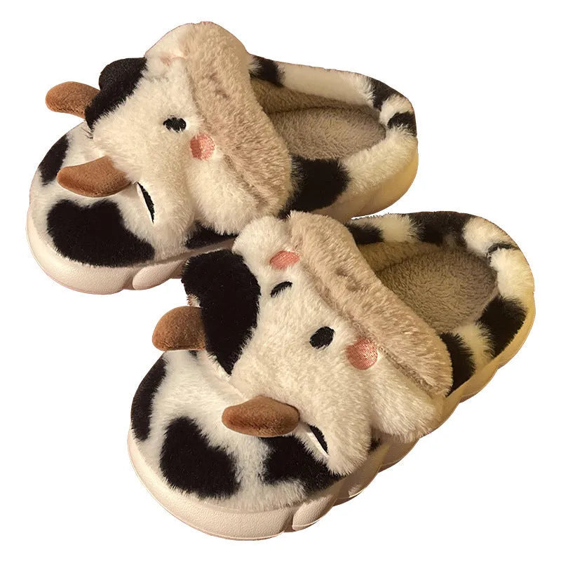 White cartoon cow plush slippers for women with a textured anti-slip sole.