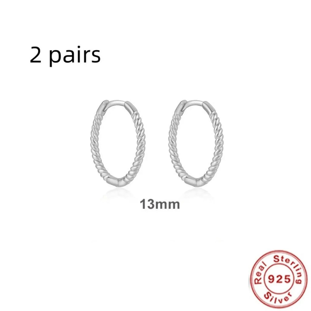 Close-up of S925 sterling silver twisted string round hoop earrings in gold finish.