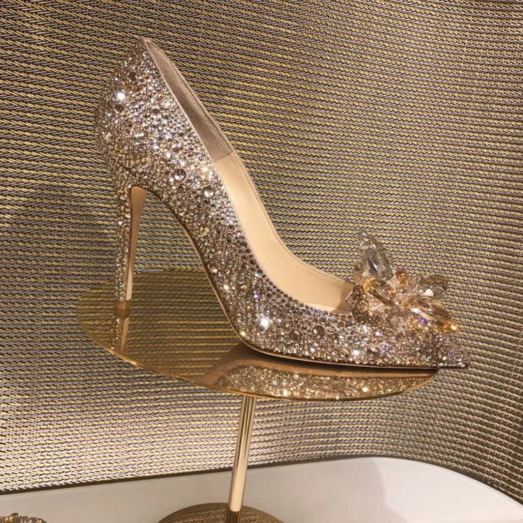 Women's gold pointed toe stiletto high heels with sequin cloth and rhinestone decoration.