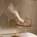 Women's gold pointed toe stiletto high heels with sequin cloth and rhinestone decoration.