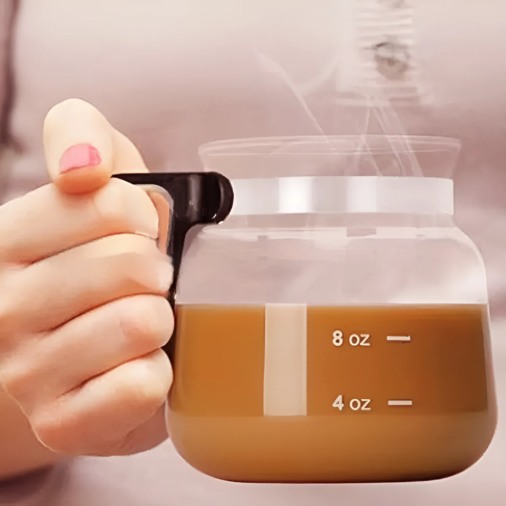 Transparent borosilicate glass coffee jug with black silicone cover on a kitchen counter