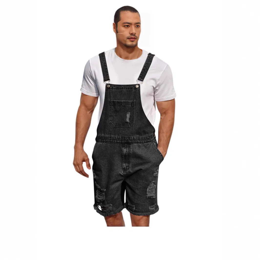 Man wearing ripped dark blue denim shorts with black suspenders attached, showing straight-leg cut.