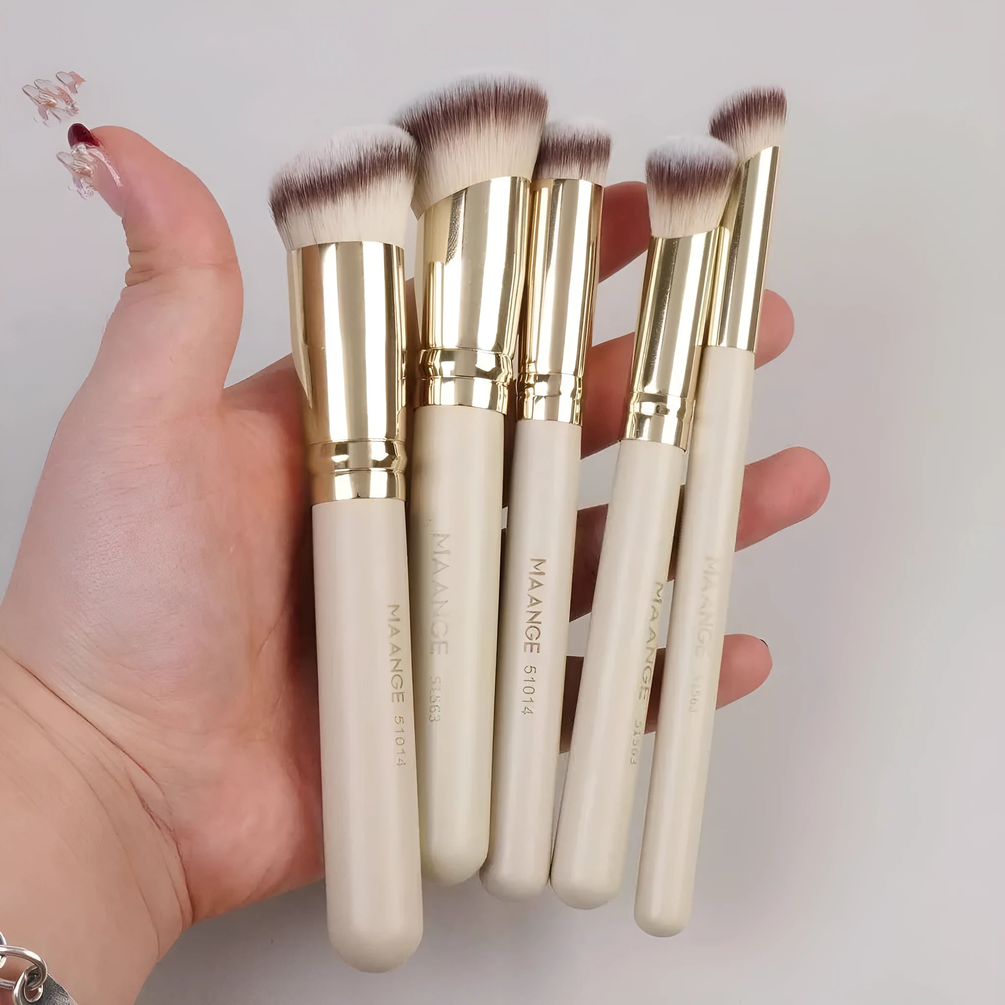 Five apricot-coloured angled blush makeup brushes for foundation and powder application