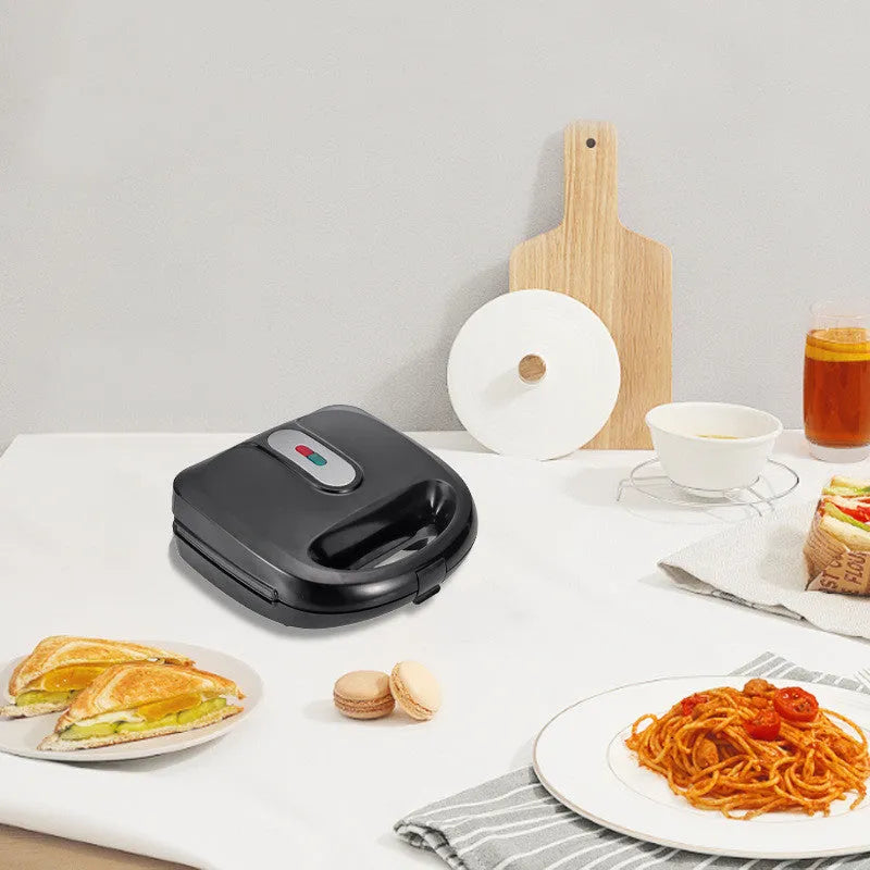 Black electric sandwich pan with stainless steel cover and non-stick baking surface
