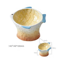 Set of four coloured fish-shaped ceramic cat bowls with a tilted, elevated design on a table.