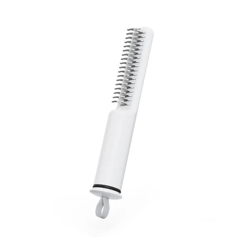 Pink and white stainless steel dematting comb for dogs with ergonomic handle on a plain background.