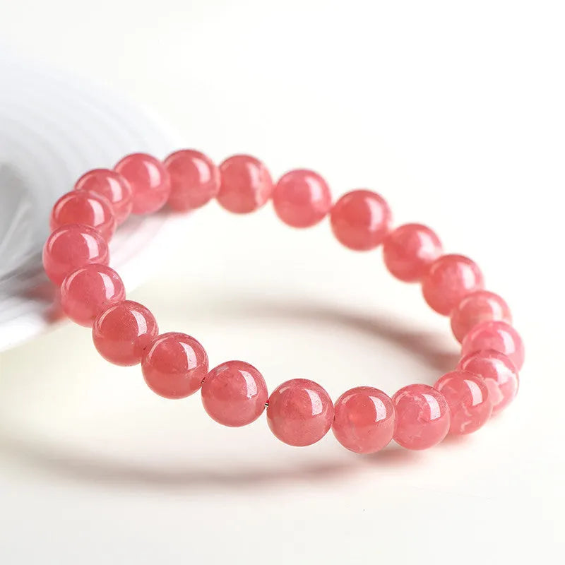 Women's crystal bracelet with red rhodochrosite stones in geometric design featuring longevity lock element