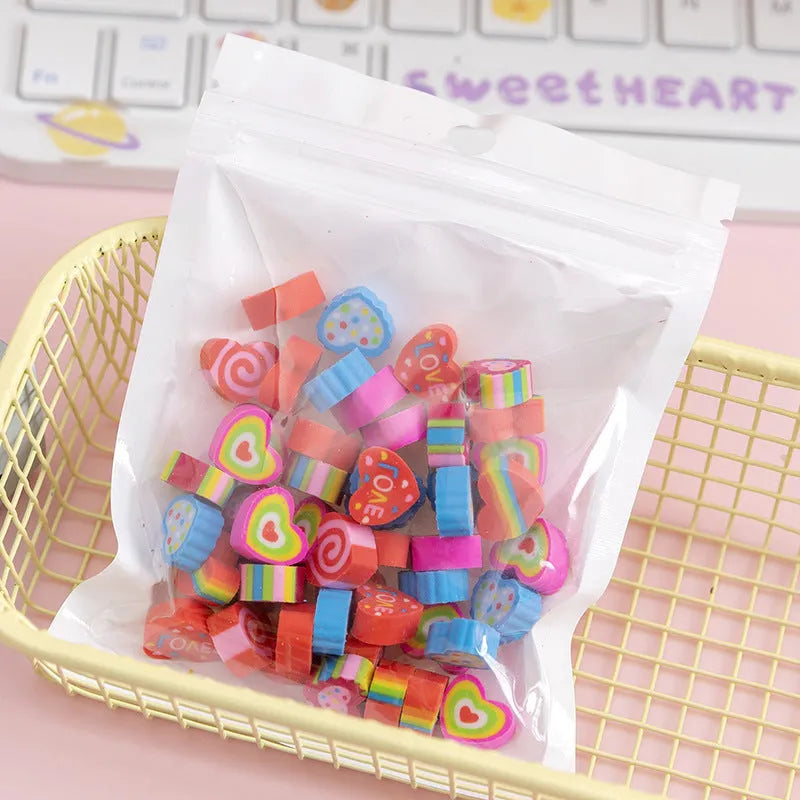 Assortment of fifty small cartoon-shaped rubber erasers in fruit and animal designs.