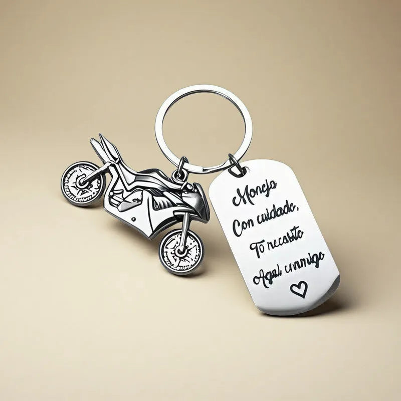 Stainless steel keychain with a motorcycle design presented on a velvet cloth.