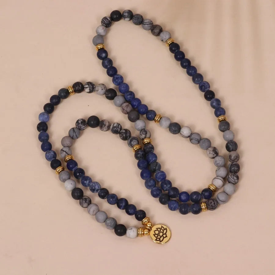 Blue multi-layer bracelet with patterned network stone beads on an alloy chain.