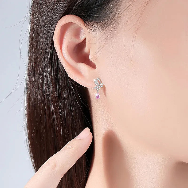 Close-up of women's butterfly stud earrings in sterling silver with clear rhinestone details.