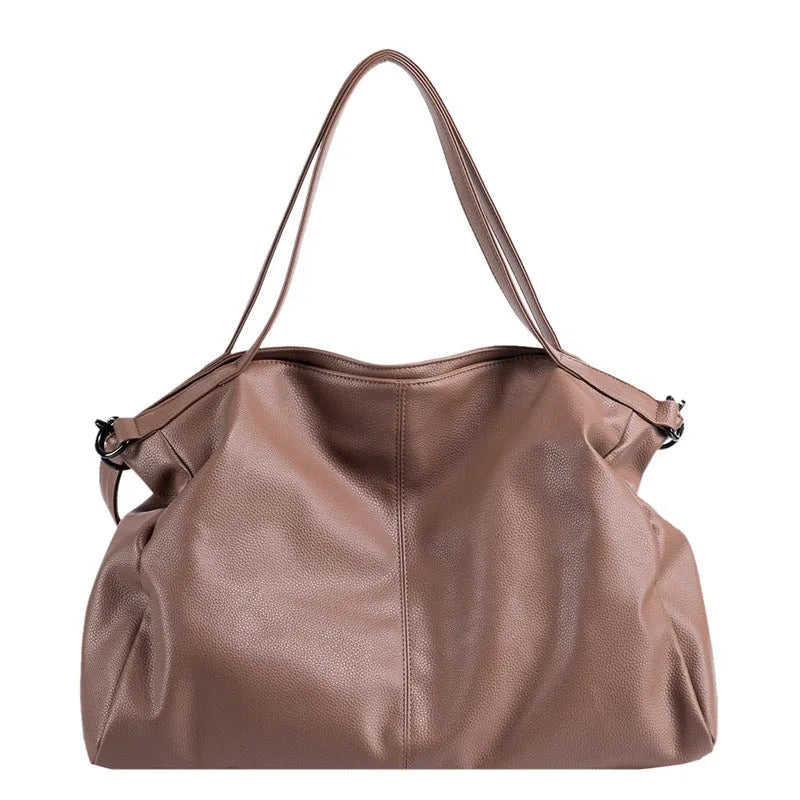 Large soft surface messenger bag showing horizontal square shape with adjustable shoulder strap and zip opening