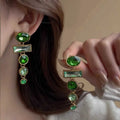 A pair of green gradient tassel earrings with geometric alloy settings and inlaid zircon stones.