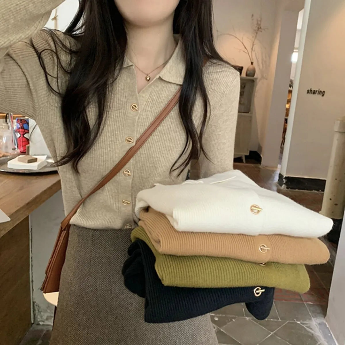 Beige loose fit long-sleeved viscose knitted cardigan top on a hanger.