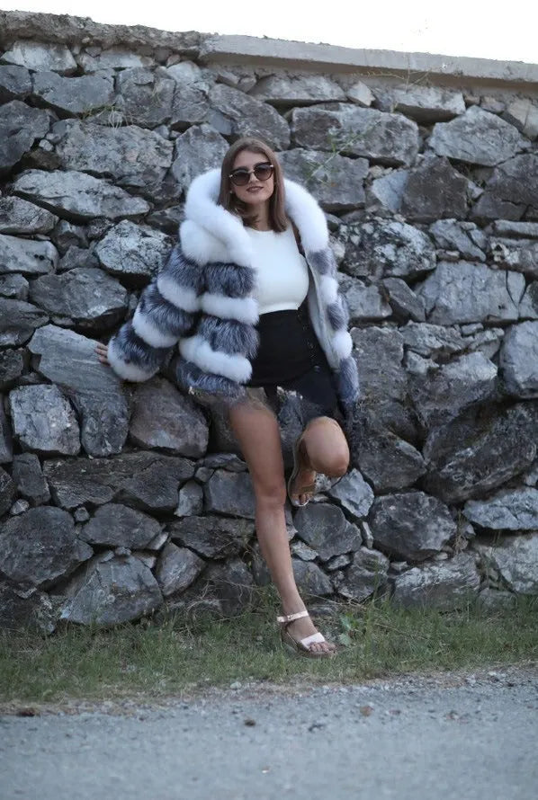 Women's loose fit hooded faux fur coat in brown on a model, showing medium length and street fashion style.