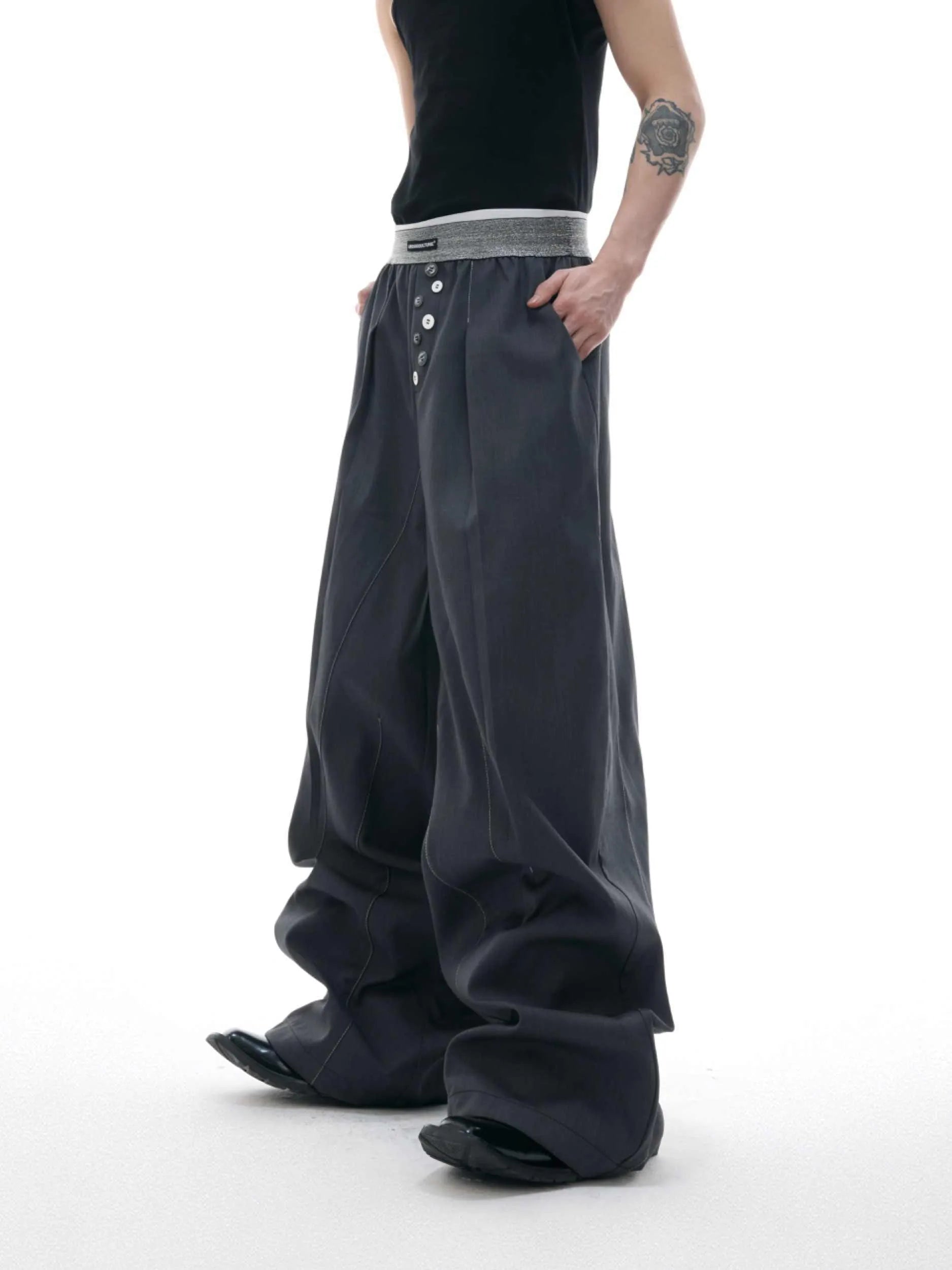 Men's high-waisted straight-leg casual trousers in black with button fly front, showing relaxed fit.