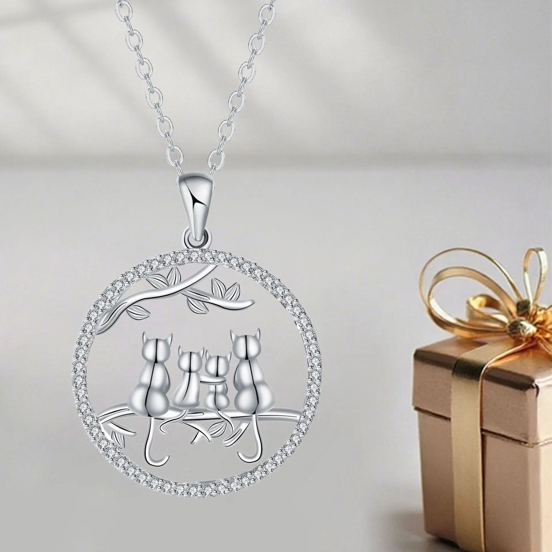 Women's copper necklace with a four kitten pendant on a cross chain, electroplated finish.