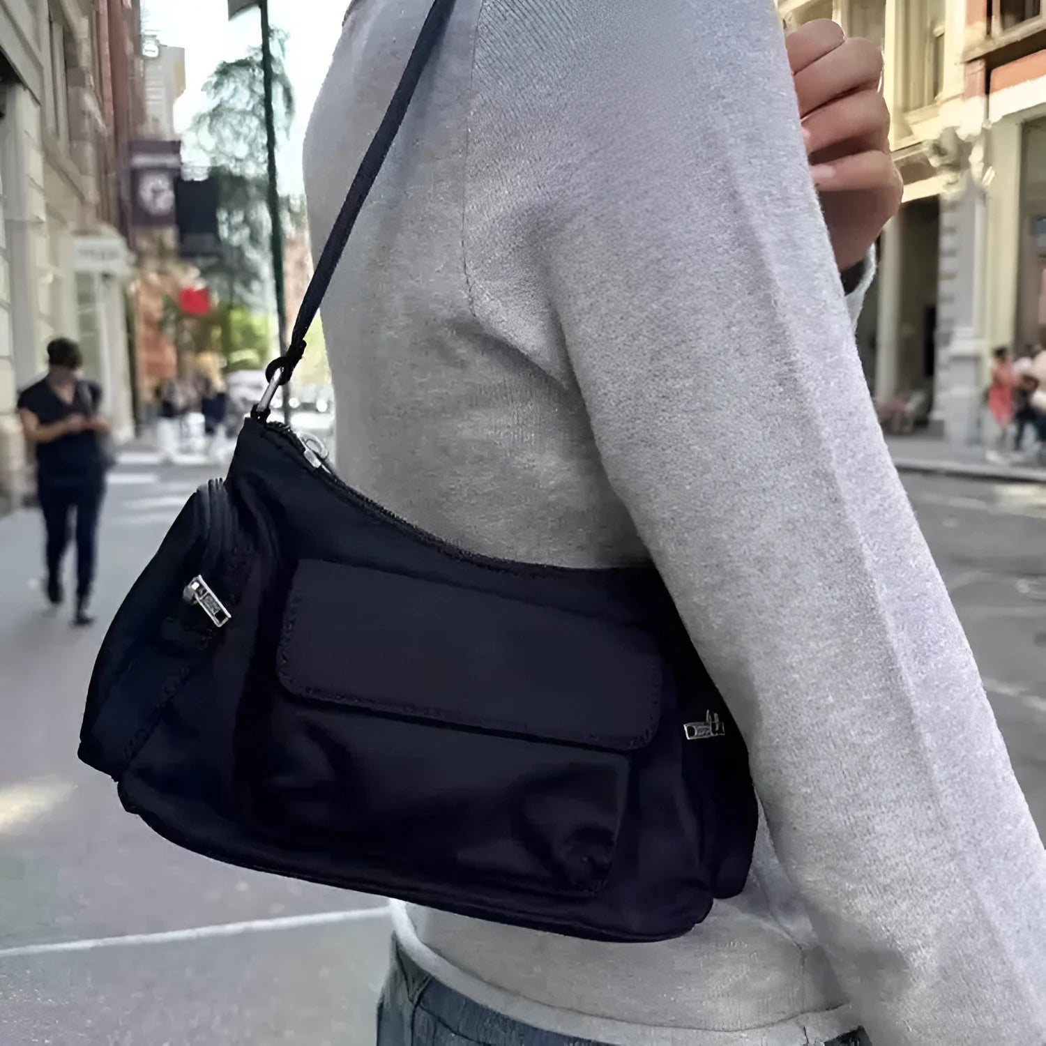 Black lightweight PU women's shoulder bag with two front pockets showing side stitching detail