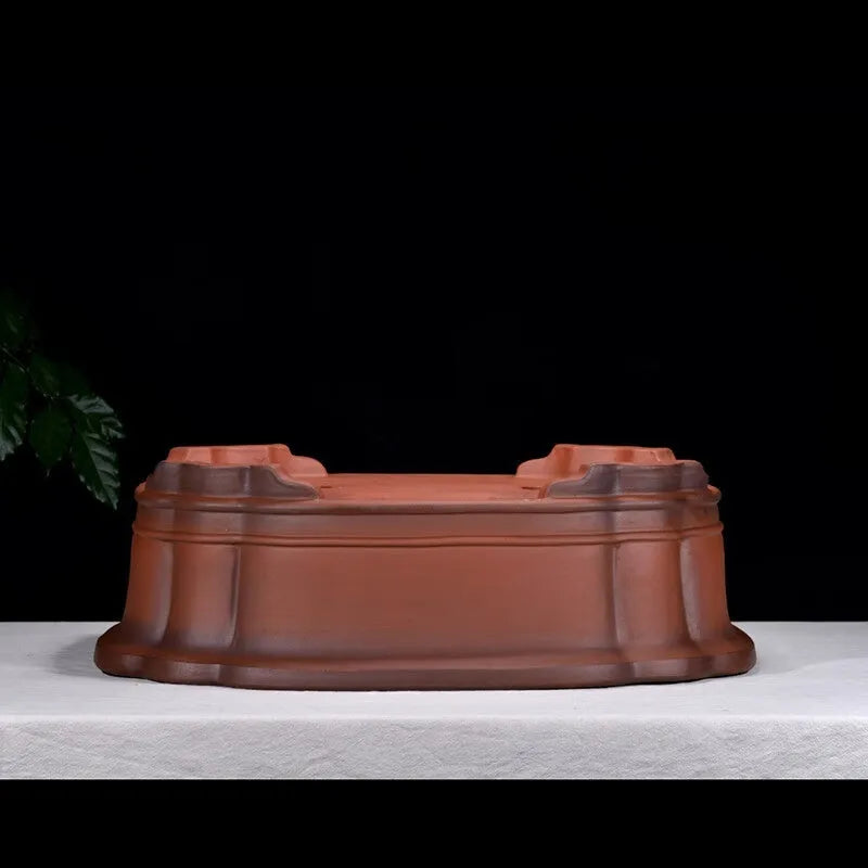 Large antique-finish Chinese purple clay flower pot with detailed tree stump and floral motif sculpture.