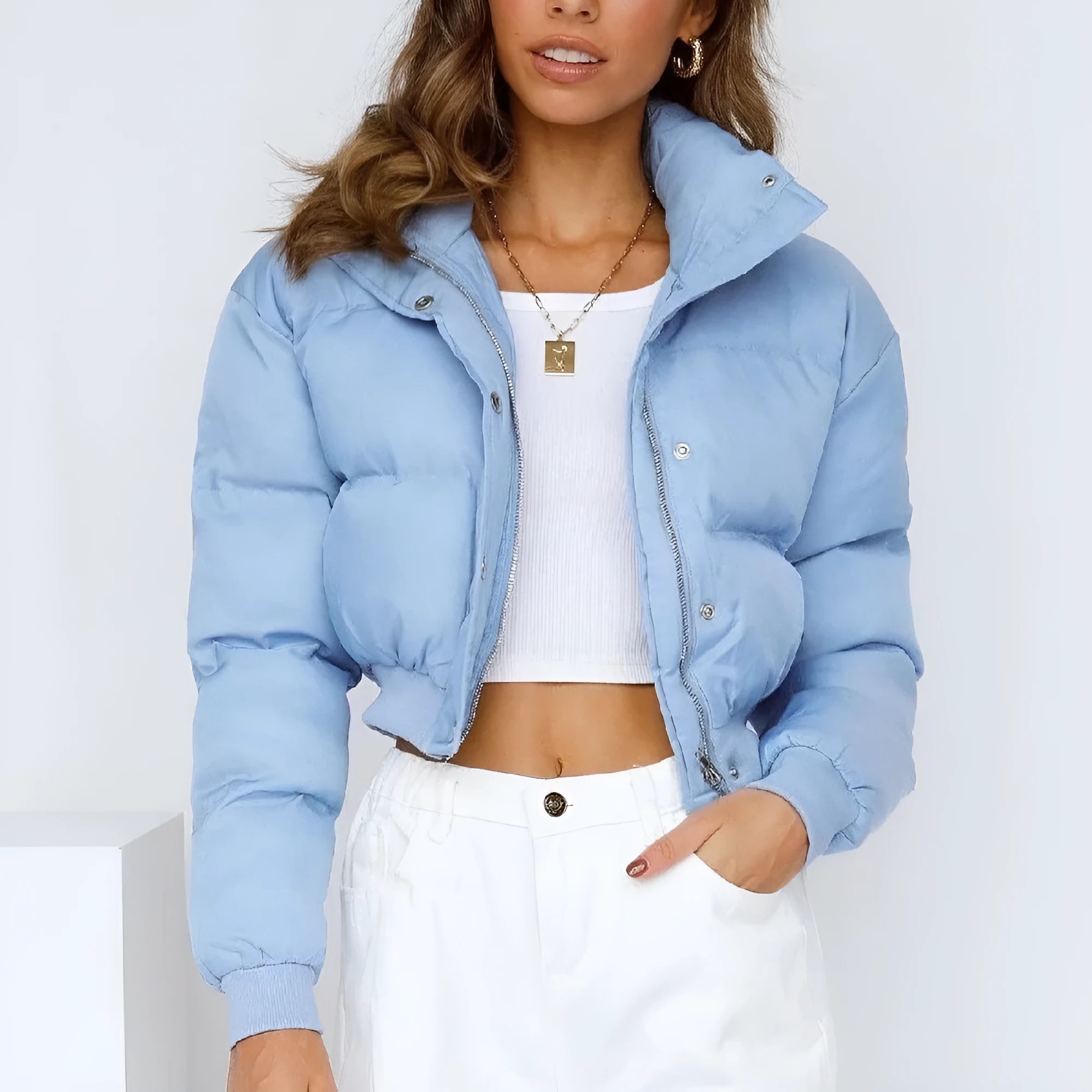 Loose fit blue polyester jacket for women on a hanger, showing long sleeves and front closure.