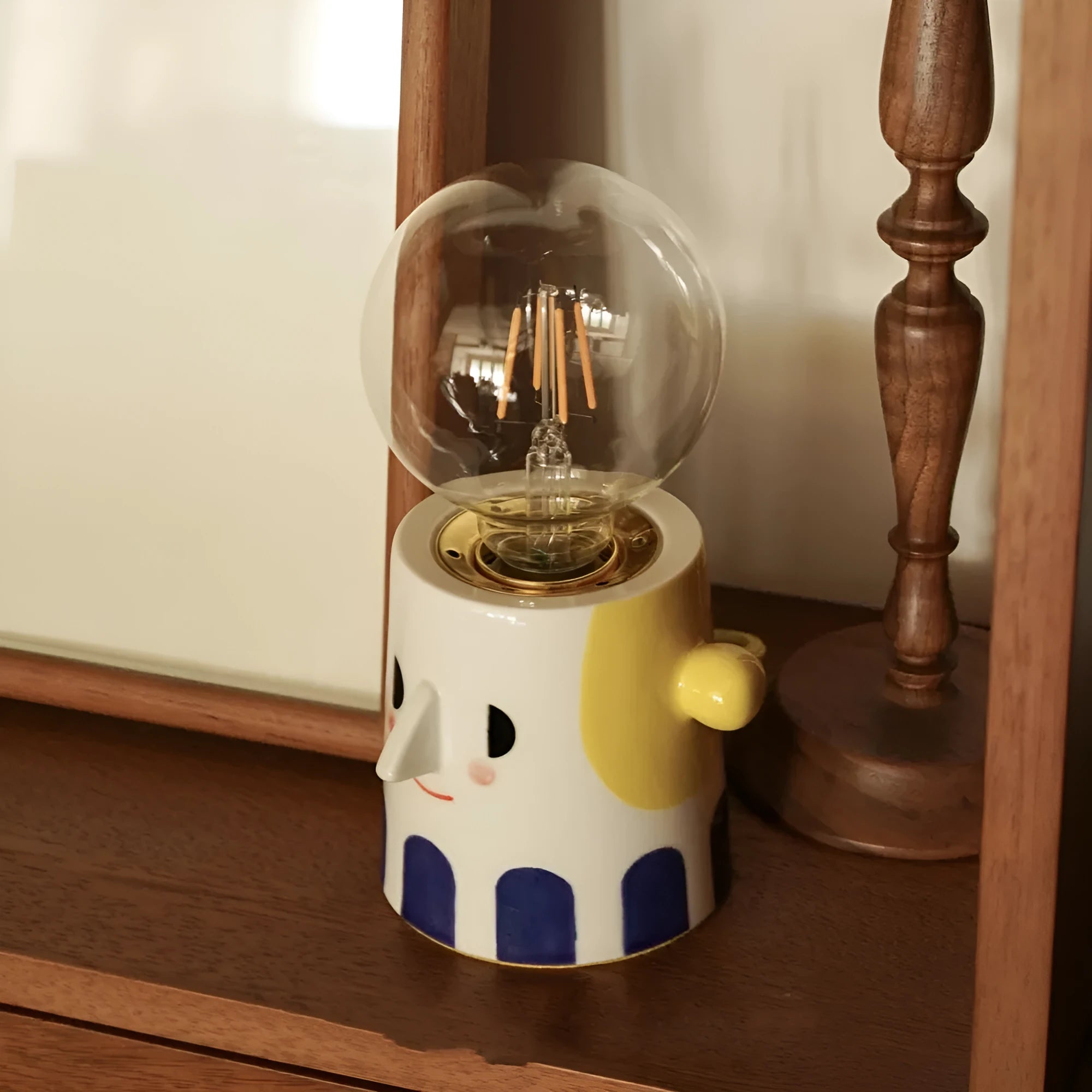 Handmade ceramic bedside lamp with ball headlight colour on wooden table