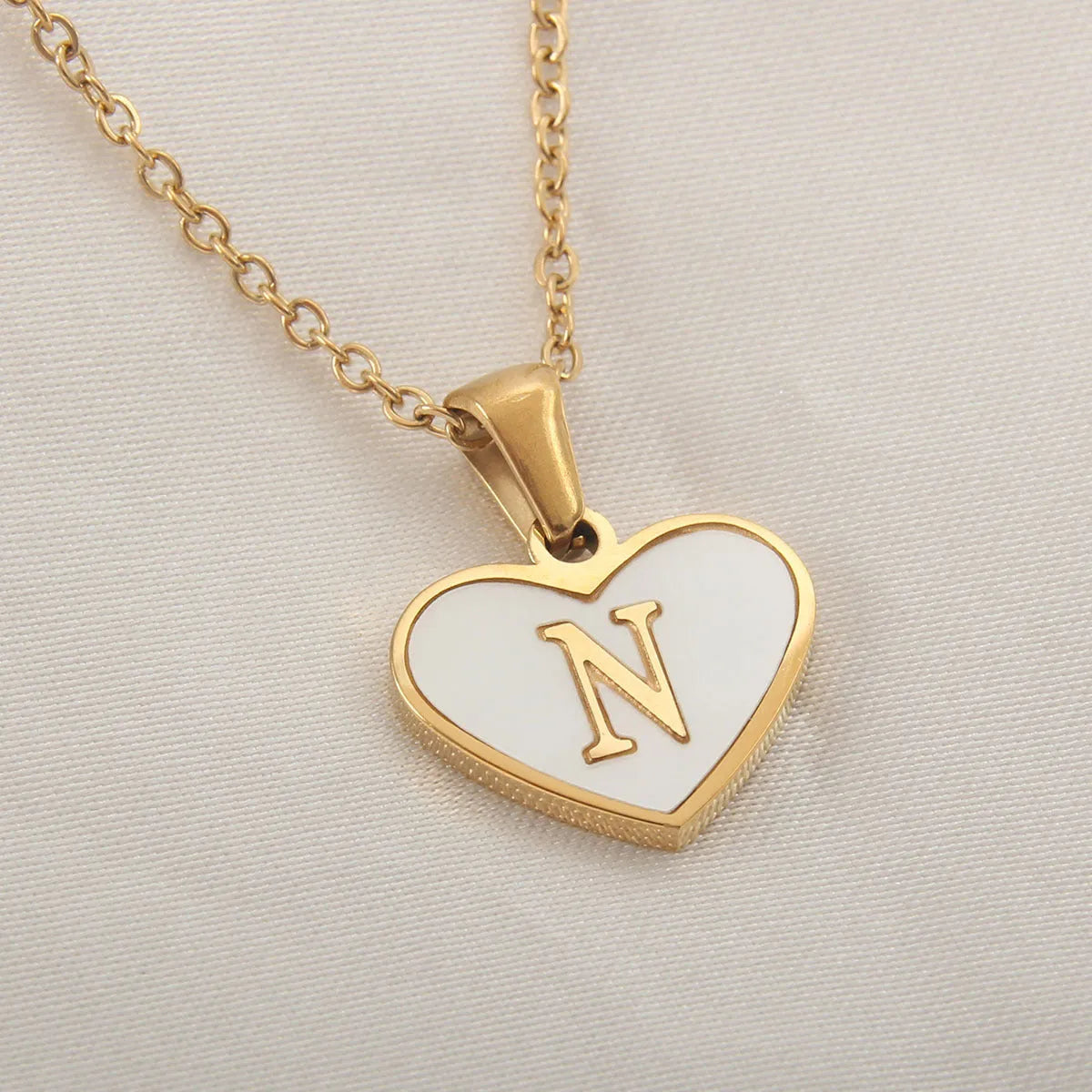 Gold heart necklace with white shell pendant and initial charm on 45cm adjustable chain
