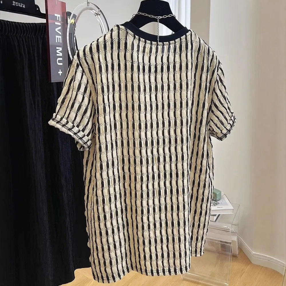 Black and white striped men's short sleeve loose fit pullover shirt on a hanger.