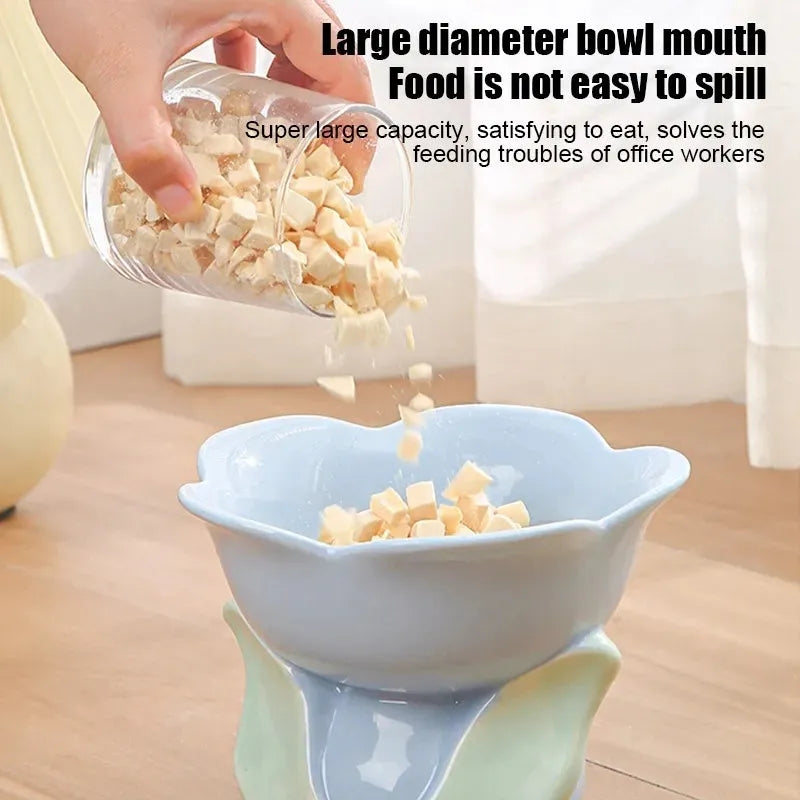 Blue ceramic elevated pet feeding bowl with floral pattern and non-slip base
