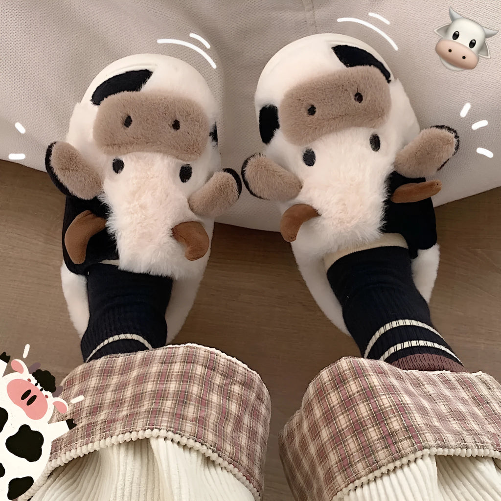White cartoon cow plush slippers for women with a textured anti-slip sole.
