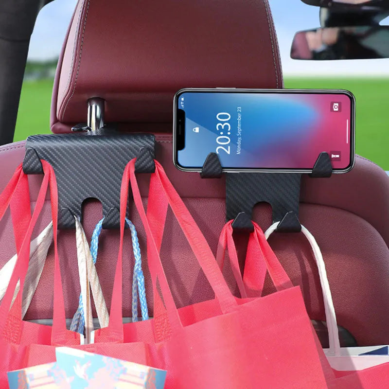 Black ABS car multifunction hook with carbon fibre pattern and integrated phone bracket for rear seat storage.