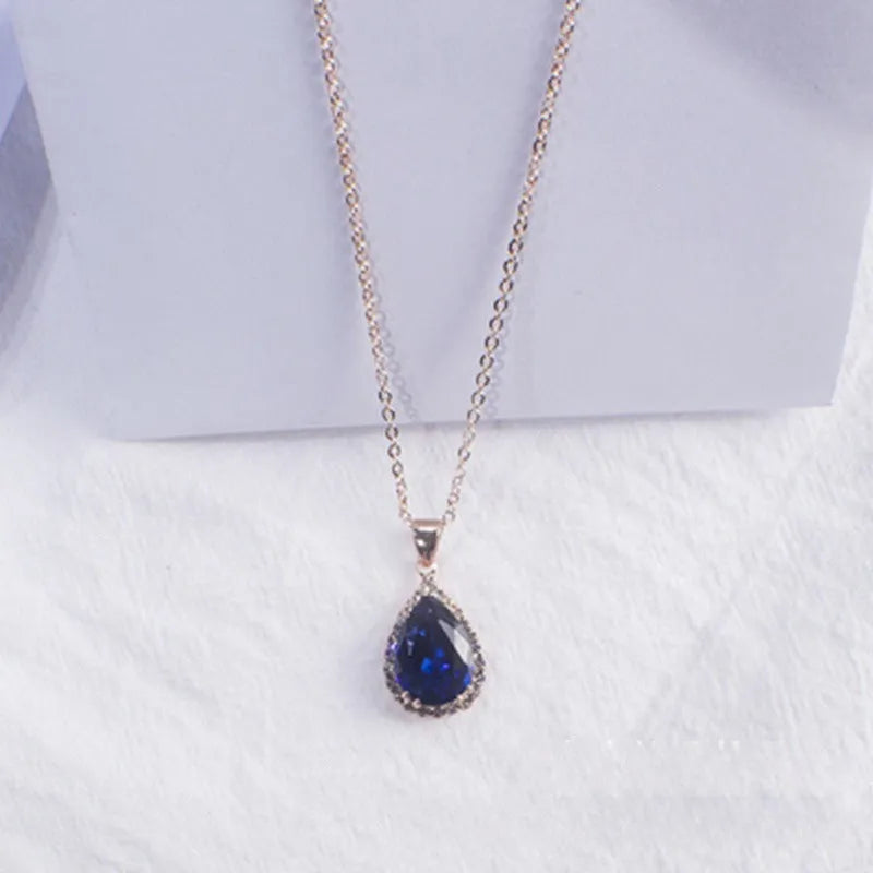 Women's pink rhinestone drop necklace with rose gold electroplated finish and geometric design