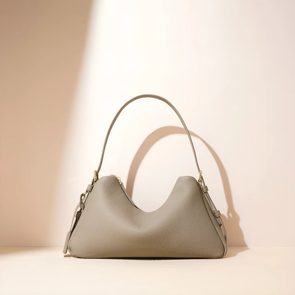 First layer cowhide leather pillow shape handbag in elephant gray with shoulder strap and open outer pocket