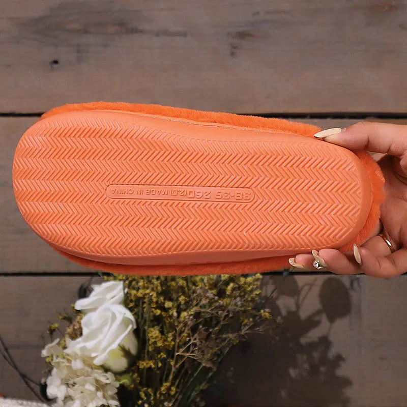 Orange Halloween pumpkin slippers with coral velvet upper and plush lining.