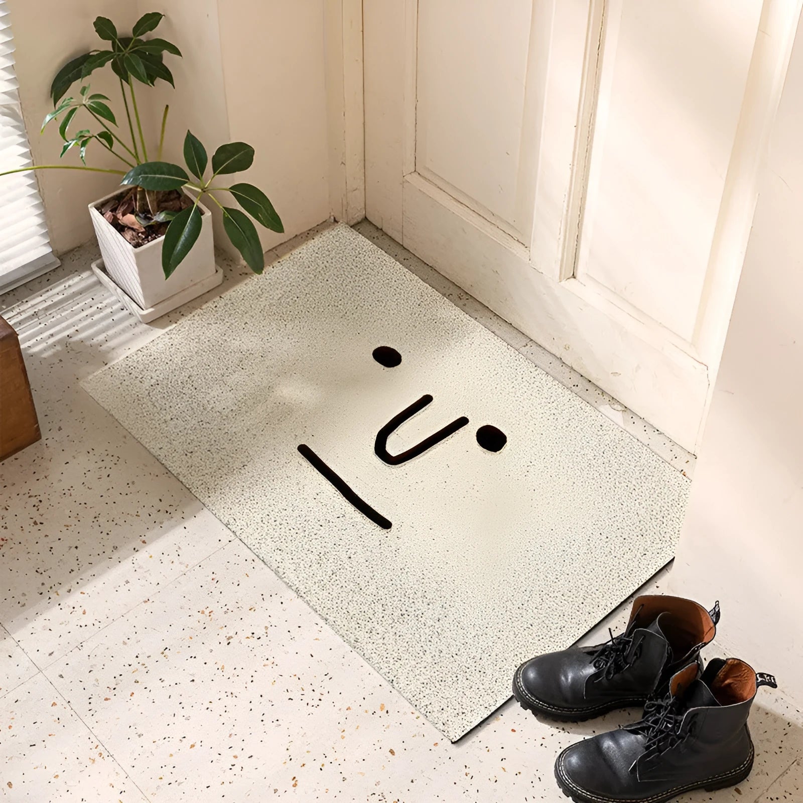 Square PVC floor mat with a geometric cartoon face pattern in Mr Big Nose colours.