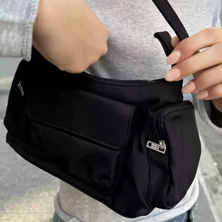 Black lightweight PU women's shoulder bag with two front pockets showing side stitching detail