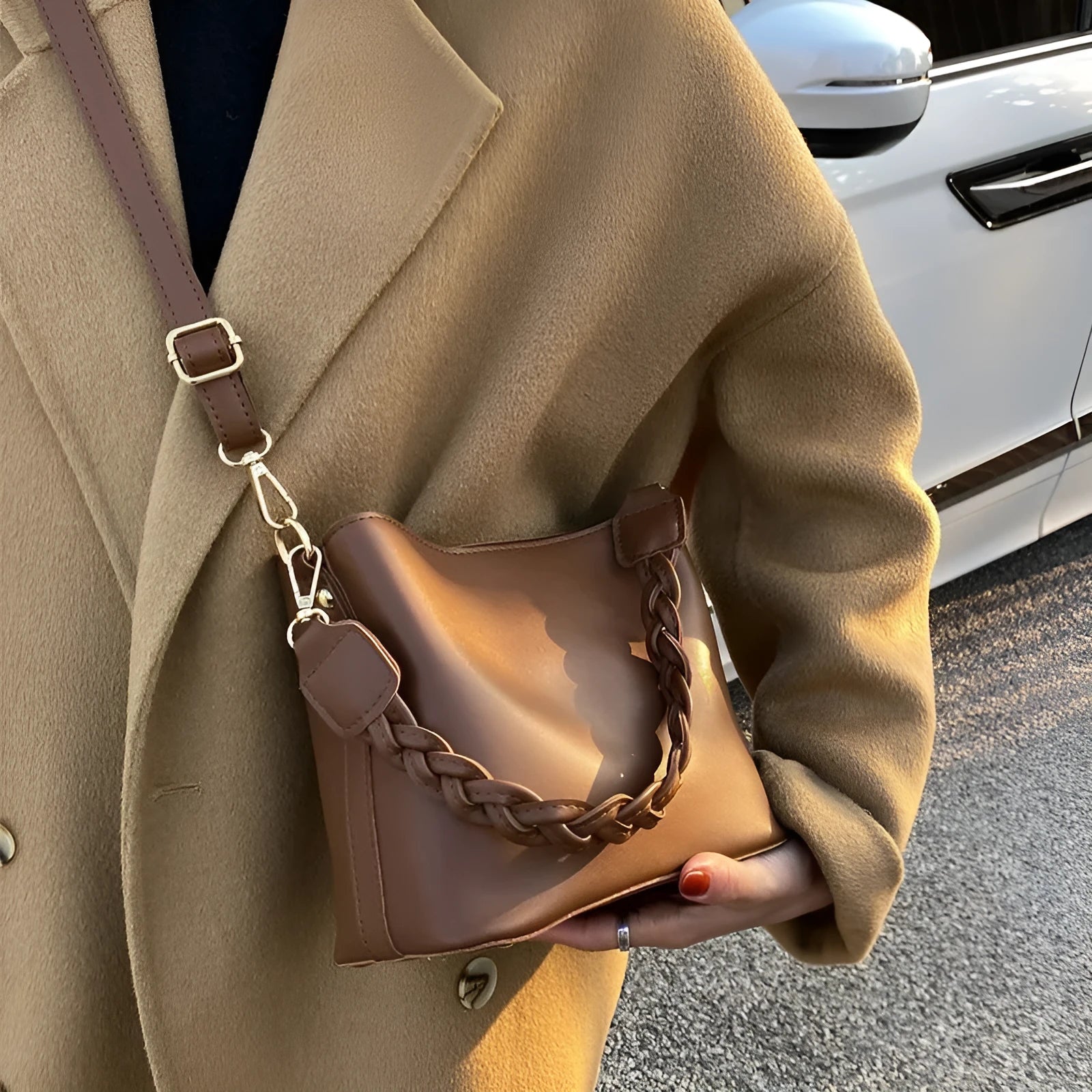 Unisex khaki PU leather crossbody bucket bag with woven texture and one shoulder strap.