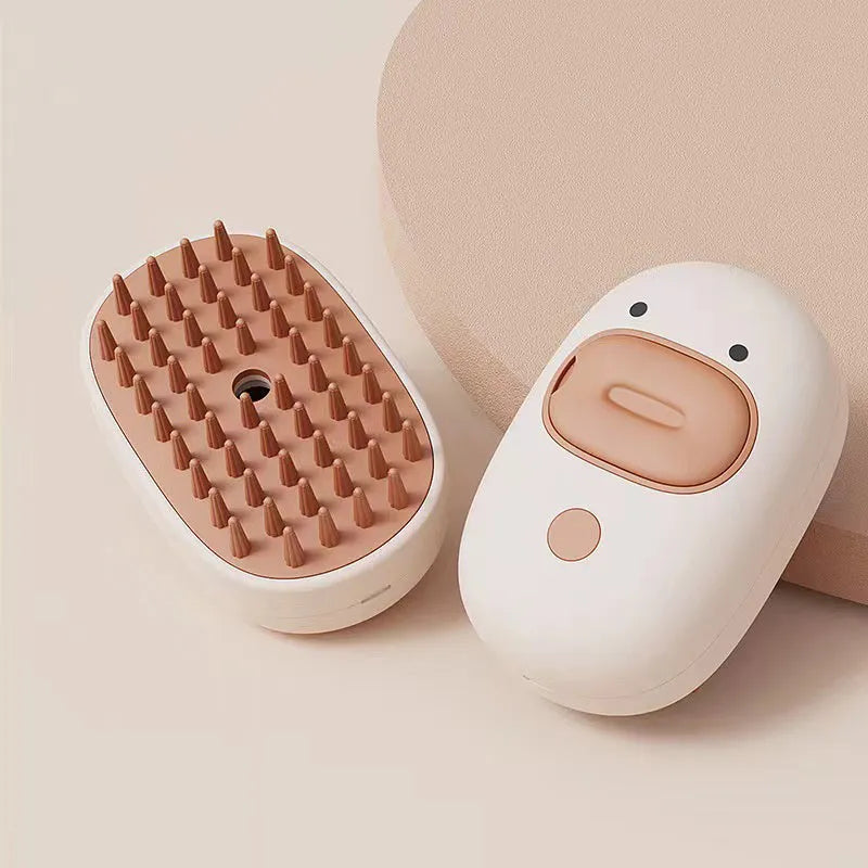 White and yellow rechargeable steam brush for grooming dogs and cats on a table.