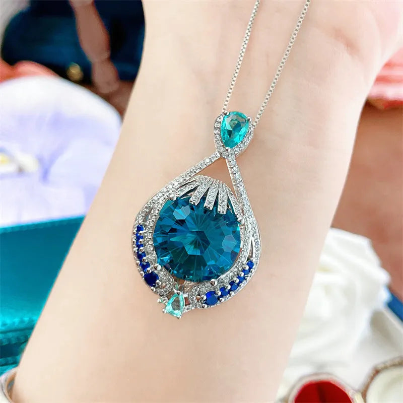 Geometric women's necklace with blue crystal pendant on water wave chain