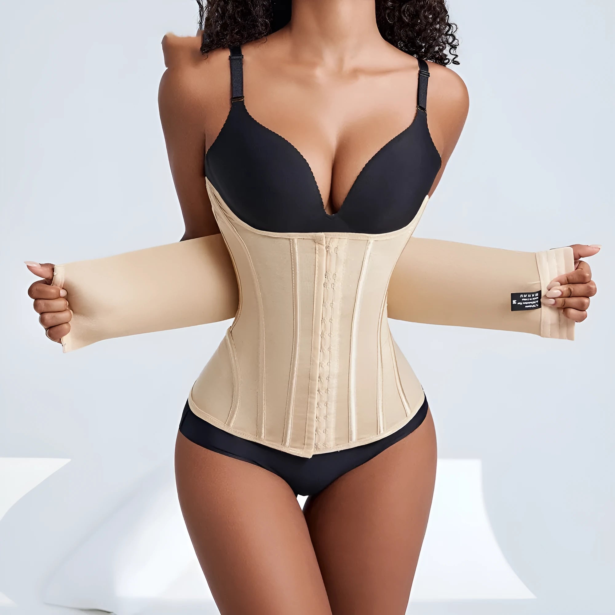 Black and apricot nylon belly band for waist training with adjustable belt tie, shown in various sizes.