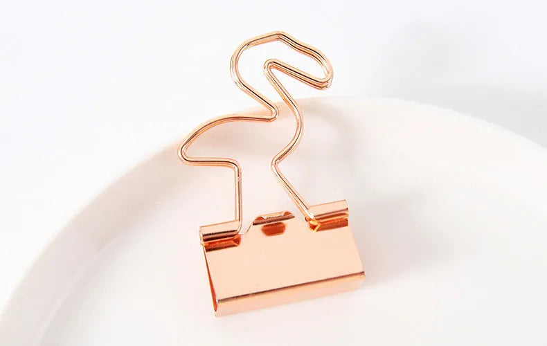 Gold-plated long tail hair clip showing decorative motifs including flamingo, love, clouds, cat, cactus, and bow designs