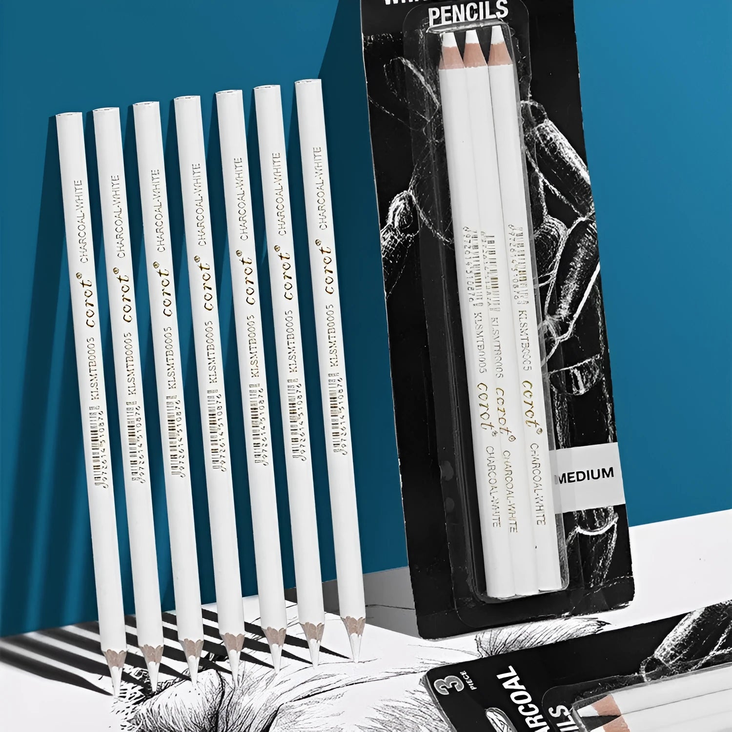 White charcoal pencil set showing wooden barrels with 144 pieces organised across 3 packs for sketching